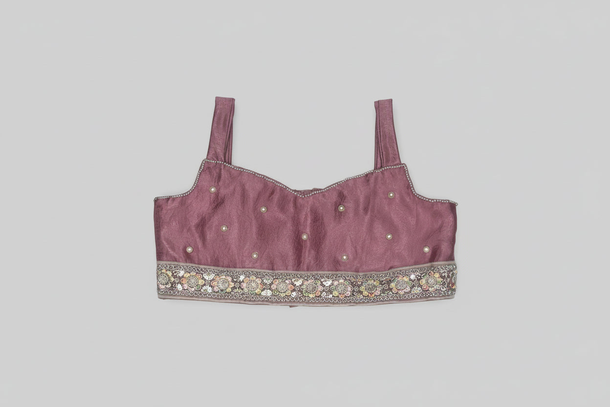 Maroon embroidered top on a textured gray background