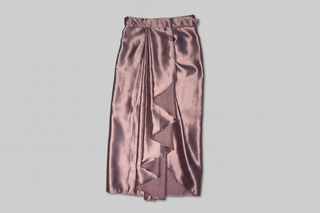 Satin skirt with ruffled detailing on a textured surface