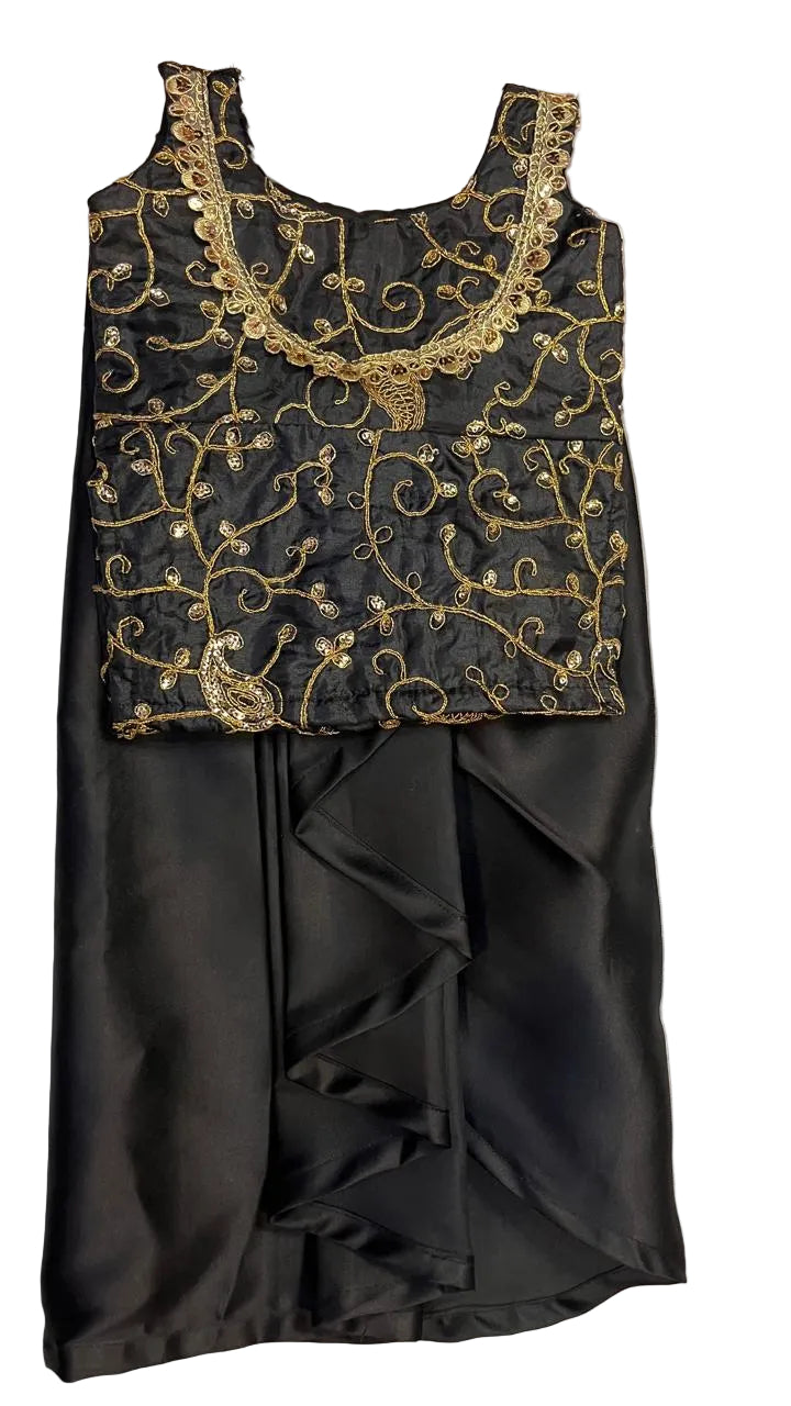 Black dress with gold embroidery on a textured surface