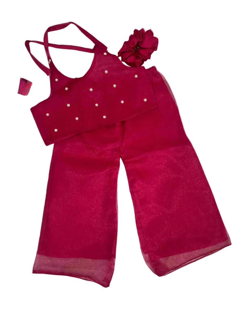Pink traditional outfit with matching headpiece on a gray background