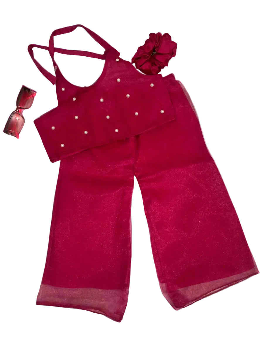 Red outfit with matching top and pants on a gray background