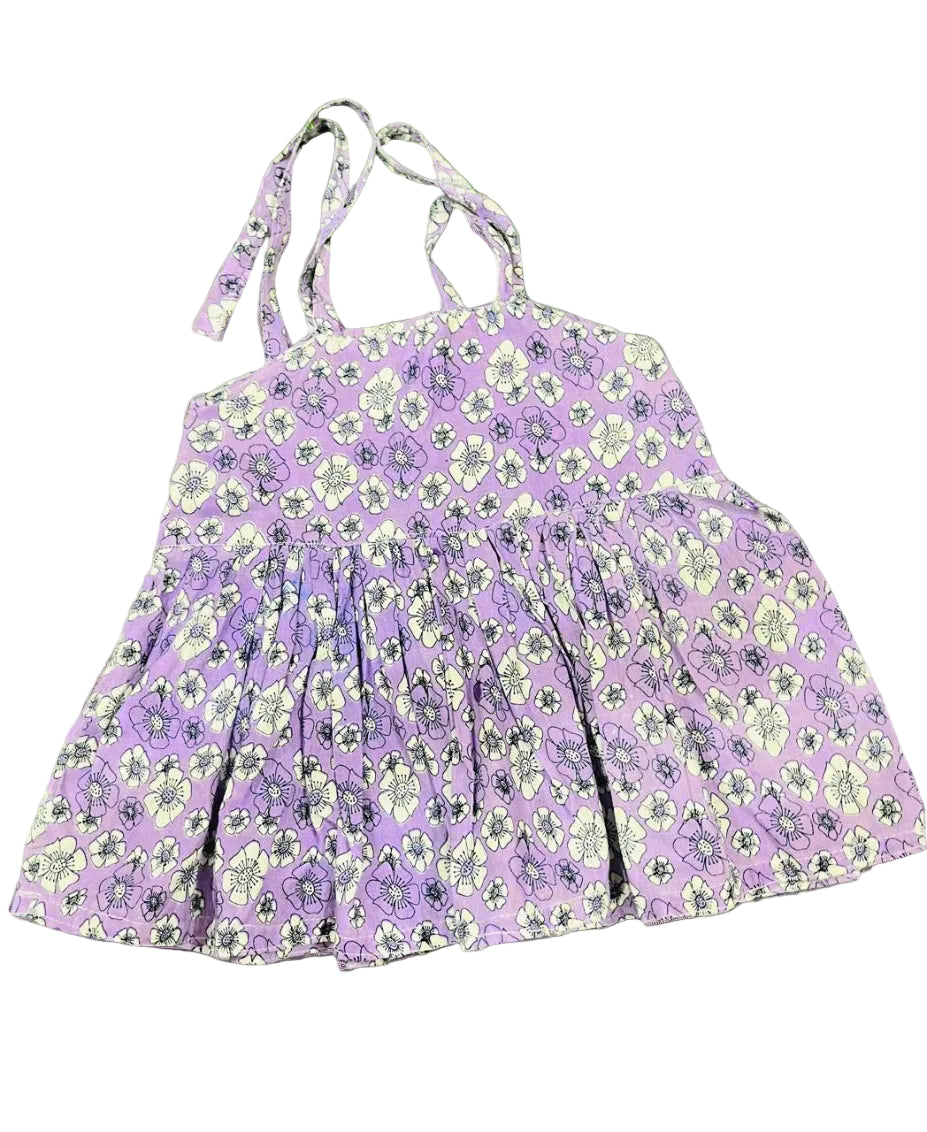 Purple floral dress with thin straps on a gray background