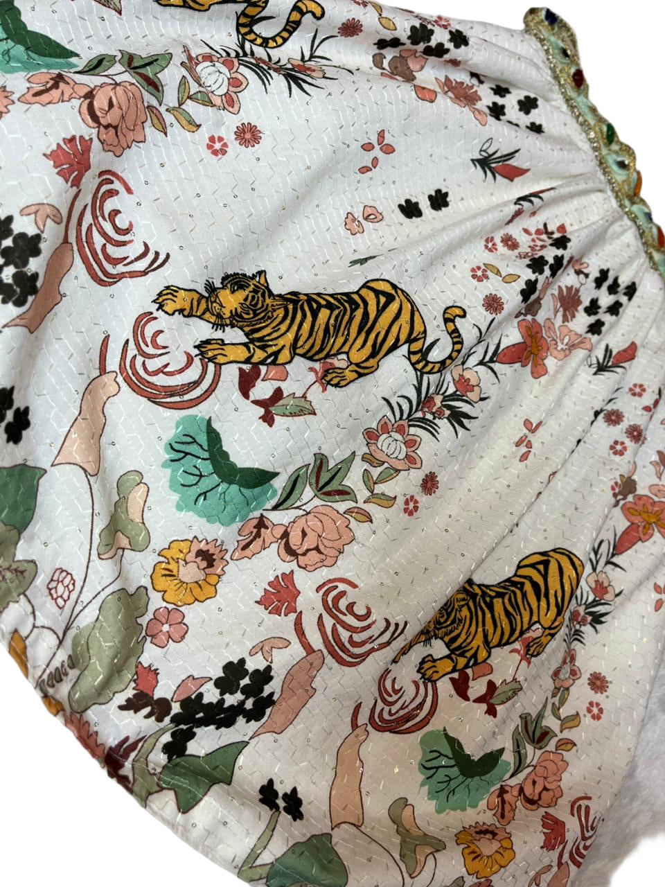 Fabric with tiger and floral pattern on a white background