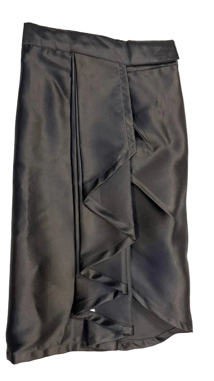 Black ruffled skirt on a textured gray background