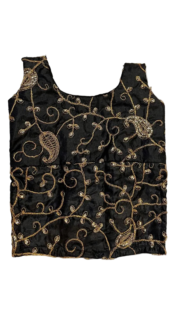 Black embroidered top with gold patterns on a textured white background