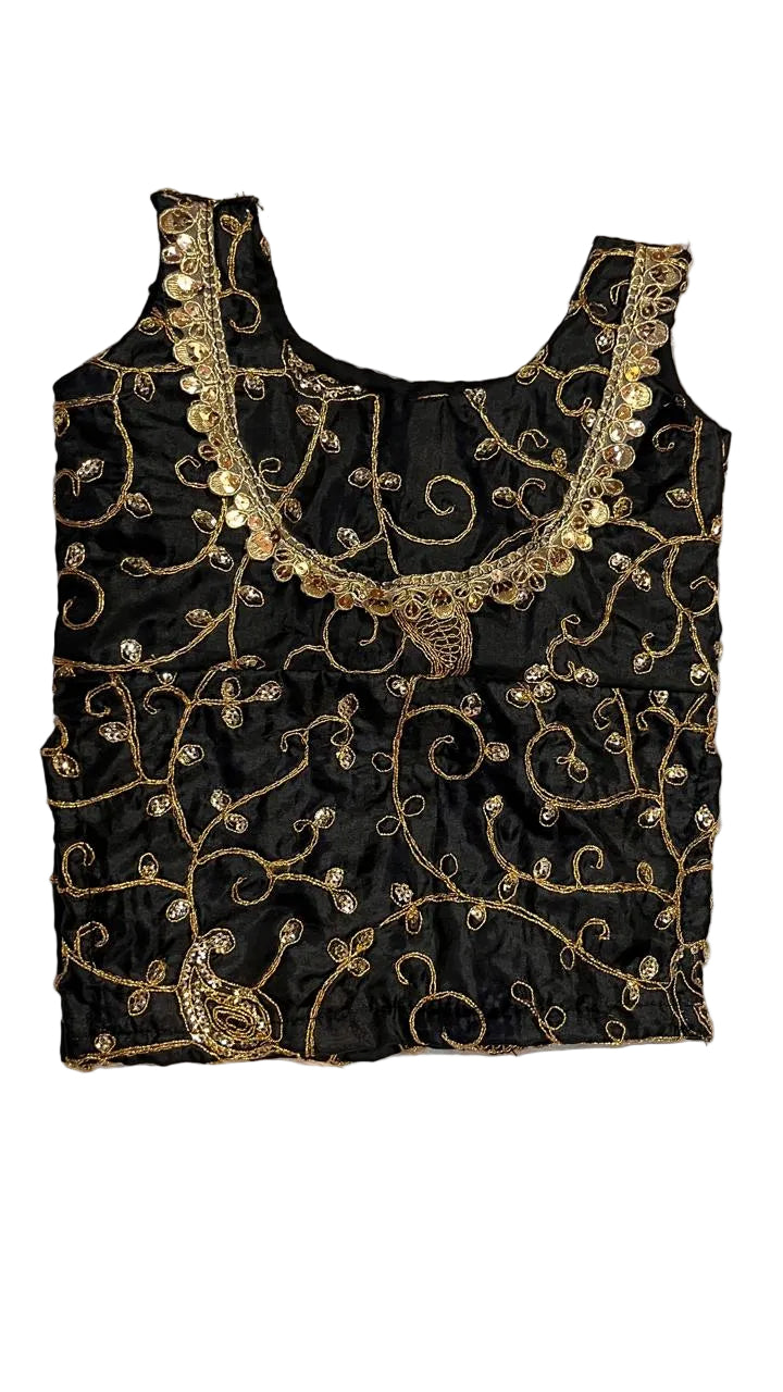 Black embroidered top with gold details on a white fur background